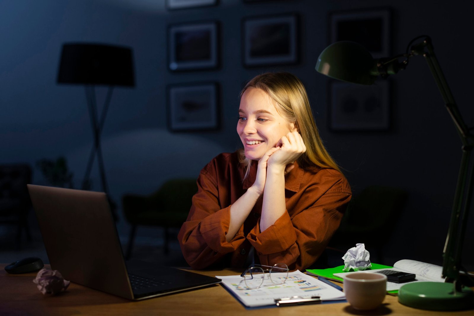 Woman smiling while working at a laptop